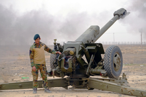An Afghan soldier fires a 122mm howitzer during a live-fire exercise with NATO military advisers outside Kandahar Air Field (Reuters/Josh Smith)