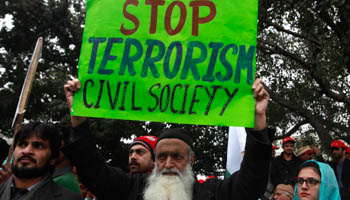 A man holds an anti-Taliban sign at a peace rally in Lahore (Reuters/Mohsin Raza)