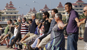 Tourists pose for a photo in front of the parliament in Naypyidaw (Reuters/Soe Zeya Tun)