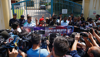 A group of people outside the North Korean embassy call for a better relationship between Malaysia and North Korea in Kuala Lumpur, Malaysia (Reuters/Edgar Su)