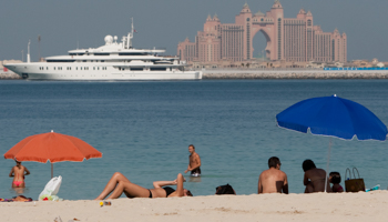 Tourists relax at Jumeirah beach in Dubai (Reuters/Steve Crisp)