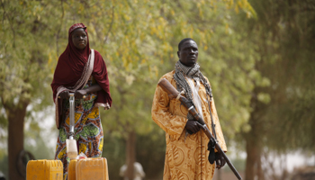 Cameroonian vigilante protects local woman (Reuters/Joe Penney)