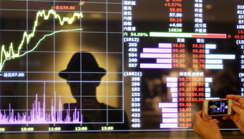 A screen showing stock market prices inside a brokerage in Taipei, Taiwan in 2015 (Reuters/Pichi Chuang)