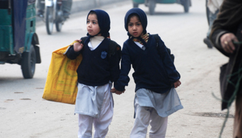 Two students walking to school in the city of Peshawar (Reuters/Khuram Parvez)