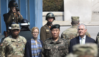 US Secretary of State Rex Tillerson, right, stands in the border village of Panmunjom as two North Korean soldiers look on, March 17 (Reuters/Lee Jin)