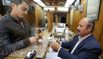 A customer exchanges US dollars to Egyptian pounds in Cairo (Reuters/Mohamed Abd El Ghany)