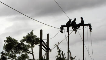 Workers repair power cable lines in Kawhmu township (Reuters/Aung Hla Tun)