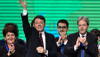 Former Prime Minister Matteo Renzi, left, waves next to Prime Minister Paolo Gentiloni at the end of Democratic Party meeting in Turin, Italy (Reuters/Giorgio Perottino)