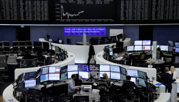 Traders work at their desks in front of the German share price index, DAX board, at the stock exchange in Frankfurt, Germany (Reuters/Staff/Remote)