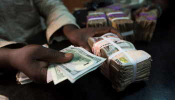 A trader changes dollars with naira at a currency exchange store in Lagos, Nigeria (Reuters/Joe Penney)
