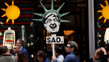 A protester demonstrates near Trump Tower against President Donald Trump in Manhattan (Reuters/Mike Segar)