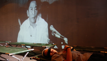 Ousted late President Ferdinand Marcos is pictured on a tv screen behind an actress portraying a martial law victim inside a People Power Experiential Museum at a military Camp Aguinaldo in Quezon City, Metro Manila (Reuters/Erik De Castro)