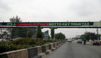 A banner campaigning for tax payment on the Lagos-Ibadan expressway (Reuters/Akintunde Akinleye)