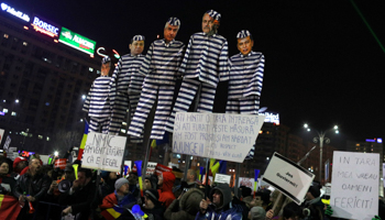 Protesters parade dummies representing PSD leader Liviu Dragnea and other PSD members dressed as prisoners in Bucharest on February 3 (Reuters/Stoyan Nenov)