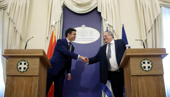 Greek Foreign Minister Nikos Kotzias, right, shakes hands with Macedonian counterpart Nikola Dimitrov during a news conference following their meeting at the Foreign Ministry in Athens on June 14 (Reuters/Costas Baltas)
