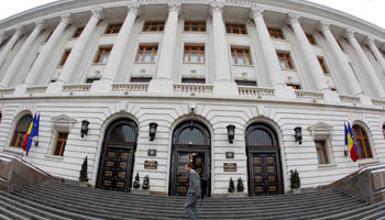 A man walks in front of Romania's Central Bank headquarters in Bucharest, Romania (Reuters/Bogdan Cristel)