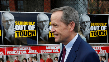 Australian Labor Party opposition leader Bill Shorten walks past election posters featuring Prime Minister Malcolm Turnbull during the 2016 campaign (Reuters/Jason Reed)