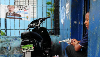 A boy playing with a toy gun in Santo Domingo, Dominican Republic (Reuters/Ricardo Rojas)