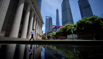 A man walks at Lujiazui financial district of Pudong in Shanghai, China (Reuters/Aly Song)