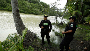 Two police officers stand near to a mangrove swamp used by drug traffickers to hide drugs, along Manuel Antonio national park in Quepos (Reuters/Juan Carlos Ulate)