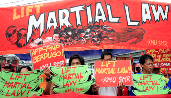 Activists display placards calling for lifting of martial law in the southern Philippines (Reuters/Romeo Ranoco)