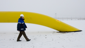 A Chinese worker of Asia Gas Pipeline walks along the pipe of the Kazakh stretch of the  Turkmenistan-China pipeline at Otar gas station outside Almaty, Kazakhstan (Reuters/Shamil Zhumatov)