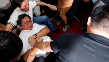 Legislators scuffle in Taiwan's parliament during a budget meeting for the infrastructure development programme (Reuters/Tyrone Siu)