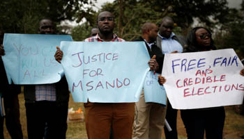 Demonstrators from the Civil society group hold placards as they protest over the death of Chris Msando, Kenya (Reuters/Baz Ratner)