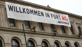 Activists of Greenpeace attach a banner that reads "Welcome to Fort NOx" to Germany's Federal Ministry of Transport and Digital Infrastructure in Berlin, Germany (Reuters/Hannibal Hanschke)