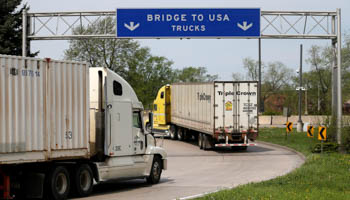 Semi trucks heading for Detroit, Michigan, drive on the lane to Ambassador Bridge in Windsor, Ontario, Canada, April 28, 2017. (Reuters/Rebecca Cook)