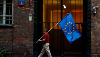 A man carries an EU flag in Warsaw after a protest against judicial reforms, July 26 (Reuters/Kacper Pempel)