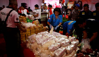 Officers from various Indonesian drug enforcement agencies with confiscated narcotics in Jakarta, Indonesia (Reuters/Darren Whiteside)