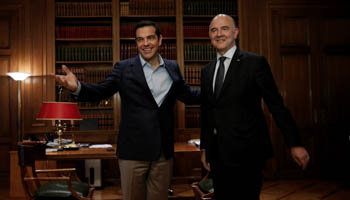 Greek Prime Minister Alexis Tsipras welcomes European Economy Commissioner Pierre Moscovici to his office in Athens on July 25, the day Greece returned to the commercial debt market (Reuters/Alkis Konstantinidis)