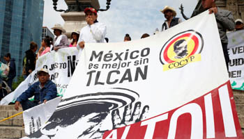 Farmers from different states, holding a banner, take part in a march against the North American Free Trade Agreement (NAFTA) talks in front of the Angel of Independence Monument in Mexico City, Mexico (Reuters/Ginnette Riquelme)