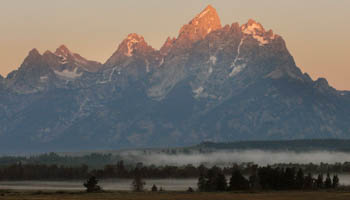 Early morning sunlight illuminates the top of the Teton mountain range in Jackson Hole, Wyoming (Reuters/Price Chambers)