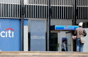 A man walks past a Citibank branch in Bogota August 20, 2014. (Reuters/John Vizcaino)