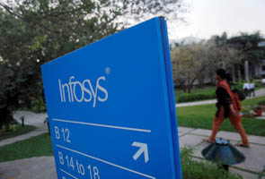 An employee walks past a signage board in the Infosys campus at the Electronics City IT district in Bangalore, February 28, 2012. (Reuters/Vivek Prakash/File Photo)