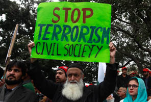 A man holds an anti-Taliban sign along with others during a peace rally in Lahore on January 5, 2015. (Reuters/Mohsin Raza)