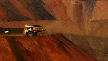 A truck carrying iron ore moves along a road at the Fortescue Metals Group (FMG) Christmas Creek iron ore mine located south of Port Hedland in the Pilbara region of Western Australia (Reuters/Jim Regan)