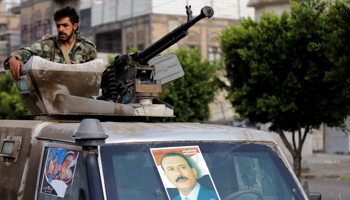 A soldier loyal to Yemen's former President Ali Abdullah Saleh mans a machine gun mounted on a military truck in Sanaa, Yemen (Reuters/Khaled Abdullah)