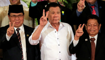 Philippine President Rodrigo Duterte, centre, with Moro Islamic Liberation Front chairperson Al Haj Murad Ebrahim, left, and Ghazali Jaafar, MILF vice-chairman at the Malacanang presidential palace in metro Manila, Philippines (Reuters/Romeo Ranoco)