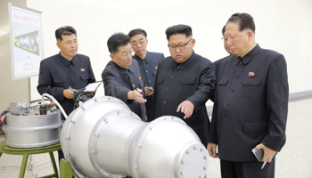 North Korean leader Kim Jong Un standing near a model of a nuclear warhead in Pyongyang (Reuters)