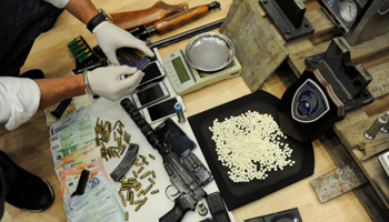 Greek authorities present confiscated guns, money and Captagon amphetamine pills, near Athens, Greece (Reuters/Michalis Karagiannis)