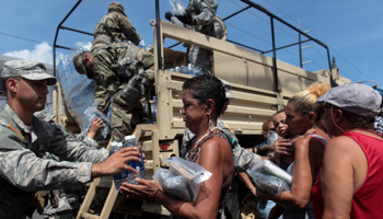 Soldiers of Puerto Rico's national guard distribute Hurricane Maria relief items in San Juan, Puerto Rico (Reuters/Alvin Baez)