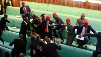 Ugandan opposition lawmakers fight with plain-clothes security personnel in the parliament ahead of the tabling of a constitutional amendment (Reuters/James Akena)