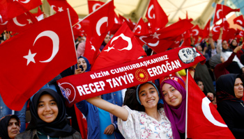Religious school students wave national flags as they wait for President Tayyip Erdogan to speak at a graduation ceremony in Istanbul (Reuters/Murad Sezer)