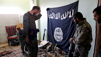 Fighters of Syrian Democratic Forces inspect weapons and munitions recovered at the former positions of the Islamic State militants in Raqqa, Syria (Reuters/Erik De Castro)