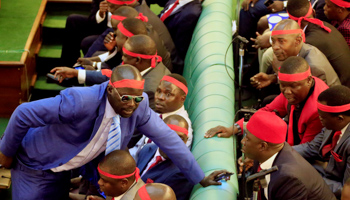 Ugandan opposition lawmakers wear red ribbons to protest the age-limit amendment in parliament (Reuters/James Akena)