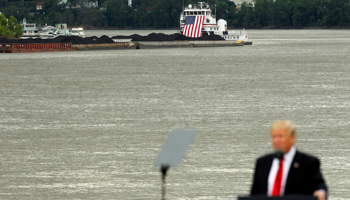 A coal barge sits behind President Donald Trump at a June rally in Cincinnati, Ohio (Reuters/John Sommers II)