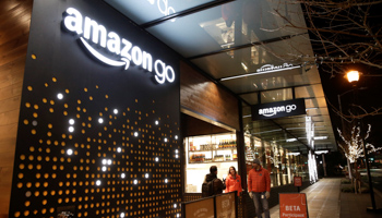 Amazon employees outside the Amazon Go brick-and-mortar grocery store in Seattle Washington, US (Reuters/Jason Redmond)